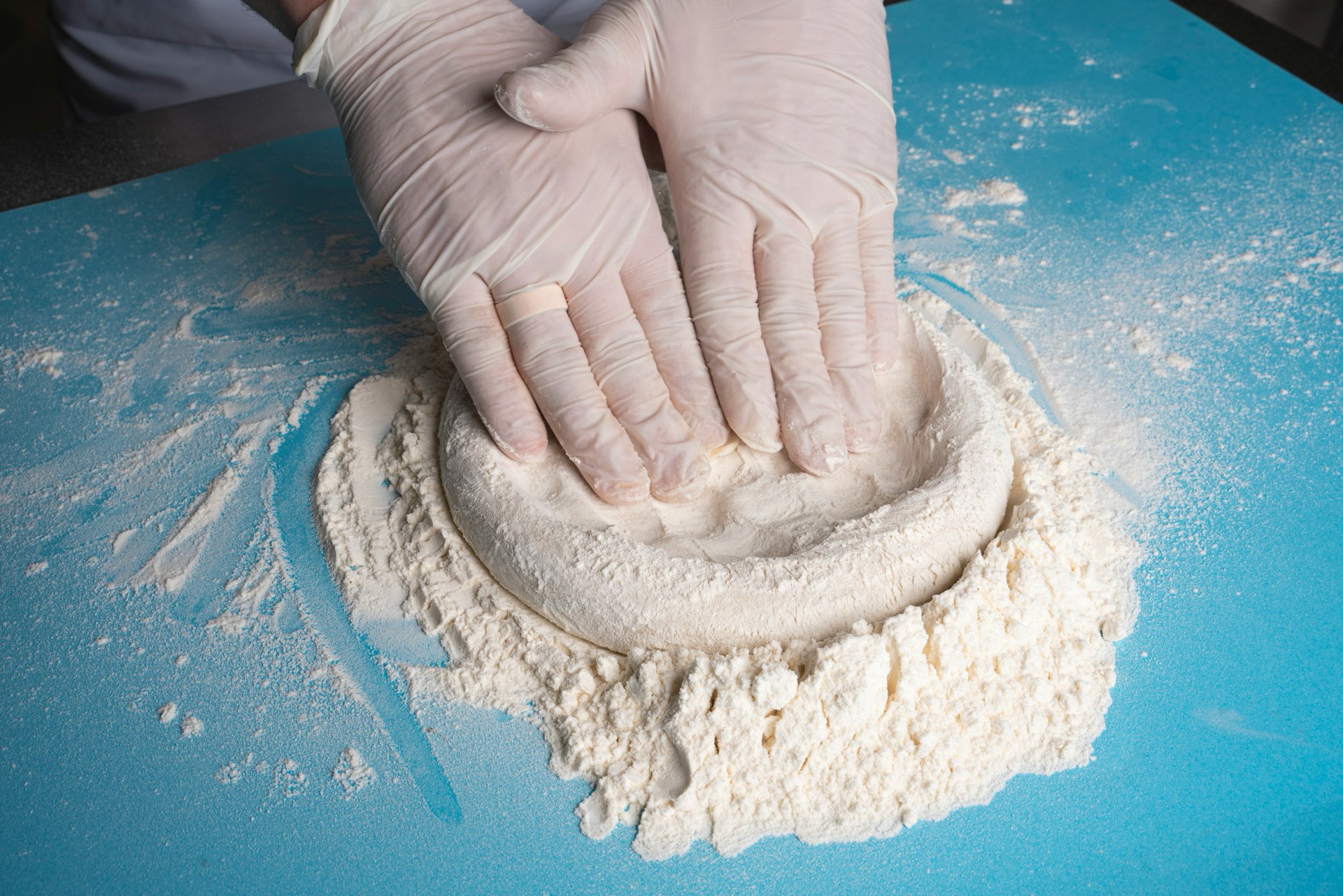a person's hand holding a white object